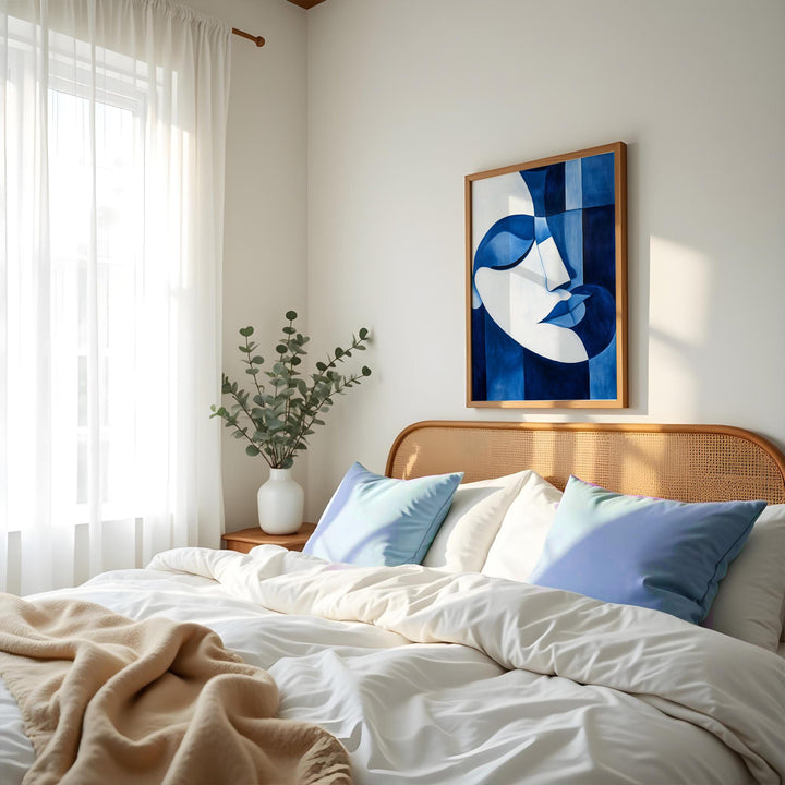 A peaceful Picasso-style abstract portrait in blue and white, bringing a sense of calm to a modern bedroom.